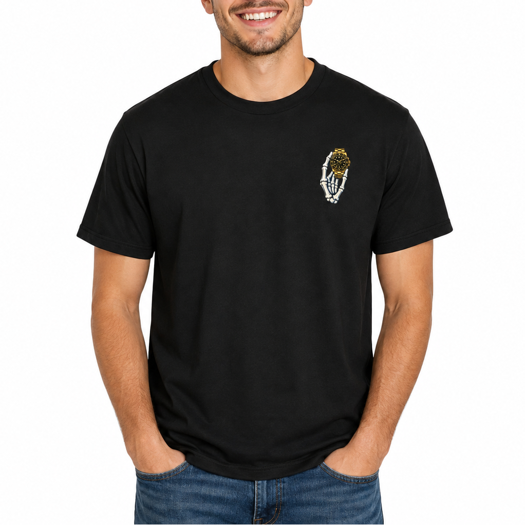 A smiling young man with curly brown hair wearing a black short-sleeve crewneck t-shirt with a small white and gold feather graphic on the left chest, paired with blue jeans, against a solid white background.